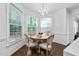Bright dining room with hardwood floors and large windows bringing in plenty of natural light at 601 Walcott Way, Cary, NC 27519