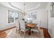 Elegant dining room with chandelier, wainscoting, and a large window at 601 Walcott Way, Cary, NC 27519