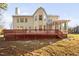 Rear exterior home view with a large deck and well maintained lawn at 601 Walcott Way, Cary, NC 27519