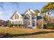 Beautiful two-story white brick home with manicured lawn and mature landscaping at 601 Walcott Way, Cary, NC 27519
