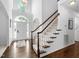 Bright foyer with hardwood floors, grand staircase, and natural light from large windows at 601 Walcott Way, Cary, NC 27519