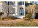 A close up of the white brick entrance, with blue trim and detailed glass front door at 601 Walcott Way, Cary, NC 27519