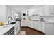 Bright kitchen features white cabinets, subway tile backsplash, stainless steel appliances, and hardwood floors at 601 Walcott Way, Cary, NC 27519