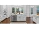 Kitchen island with marble countertops, stainless steel dishwasher, and modern fixtures at 601 Walcott Way, Cary, NC 27519