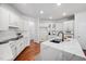 Modern kitchen with white cabinets, stainless steel appliances, and quartz countertops at 601 Walcott Way, Cary, NC 27519
