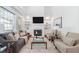 Open living room with tall ceilings, built-in shelving, fireplace, and large windows at 601 Walcott Way, Cary, NC 27519