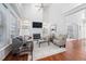 Bright and open living room with tall ceilings, built-in shelving, and a fireplace at 601 Walcott Way, Cary, NC 27519
