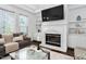 Cozy living room with a fireplace, built-in bookshelves, and comfortable seating at 601 Walcott Way, Cary, NC 27519