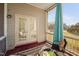Covered and screened in back porch with table and chairs, and access to backyard at 601 Walcott Way, Cary, NC 27519