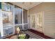 Screened in porch showcasing patio furniture and double doors at 601 Walcott Way, Cary, NC 27519
