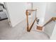 Carpeted staircase with wooden banister leading to the lower level at 601 Walcott Way, Cary, NC 27519