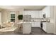 Modern kitchen with stainless steel appliances, a stylish island with barstools, and plenty of storage at 712 Shea Hill Dr, Angier, NC 27501
