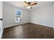 Bright bedroom with hardwood floors and large window at 7271 Shellburne Dr, Raleigh, NC 27612