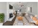 Bright living room featuring a fireplace, large window, and hardwood floors at 7271 Shellburne Dr, Raleigh, NC 27612