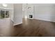 Open-concept living room with hardwood floors, fireplace, and abundant natural light at 7271 Shellburne Dr, Raleigh, NC 27612