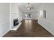 Spacious living room featuring a fireplace, large window, and hardwood floors at 7271 Shellburne Dr, Raleigh, NC 27612