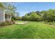 Expansive backyard features a stone fire pit and lush greenery, perfect for outdoor gatherings at 1005 Keith Rd, Wake Forest, NC 27587