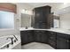 A closer look at a custom bath vanity, window, and soaking tub with black fixtures at 1005 Keith Rd, Wake Forest, NC 27587