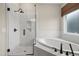 Bathroom with glass-enclosed shower, soaking tub, and tiled walls at 1005 Keith Rd, Wake Forest, NC 27587