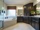 Modern bathroom featuring a soaking tub, marble floors, and dark wood cabinets at 1005 Keith Rd, Wake Forest, NC 27587