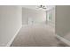 Light-filled bedroom features a window, neutral carpeting, and closet access at 1005 Keith Rd, Wake Forest, NC 27587