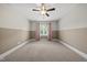 Large bedroom featuring a ceiling fan and a bright window at 1005 Keith Rd, Wake Forest, NC 27587