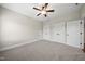 Bedroom with carpet, ceiling fan, and multiple closets and doors at 1005 Keith Rd, Wake Forest, NC 27587