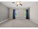 Bedroom with carpet, gray accent wall, and two windows with dark curtains at 1005 Keith Rd, Wake Forest, NC 27587