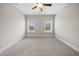 Spacious bedroom with a ceiling fan, neutral carpet, and lots of light at 1005 Keith Rd, Wake Forest, NC 27587