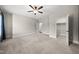 Spacious bedroom featuring neutral paint, carpet, a ceiling fan, and two closets at 1005 Keith Rd, Wake Forest, NC 27587