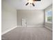 Bedroom featuring a window, neutral carpeting, and a ceiling fan at 1005 Keith Rd, Wake Forest, NC 27587