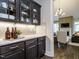 Butler's pantry featuring display cabinets, ample counter space, and modern lighting at 1005 Keith Rd, Wake Forest, NC 27587