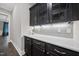 Elegant butler's pantry features sleek black cabinets and granite countertops at 1005 Keith Rd, Wake Forest, NC 27587
