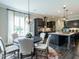 Inviting dining area with a modern chandelier and views of the well-equipped kitchen at 1005 Keith Rd, Wake Forest, NC 27587