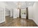 Bright dining room features hardwood floors, French doors, large windows, and a modern chandelier for a classic feel at 1005 Keith Rd, Wake Forest, NC 27587