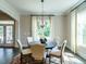Bright dining room features a round table with seating for five and a modern light fixture at 1005 Keith Rd, Wake Forest, NC 27587