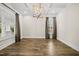 Elegant dining room with hardwood floors, large windows, custom trim, and a modern chandelier, creating a welcoming space at 1005 Keith Rd, Wake Forest, NC 27587