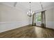 Dining room showcases hardwood floors, elegant wainscoting, modern chandelier, and abundant natural light for a warm feel at 1005 Keith Rd, Wake Forest, NC 27587