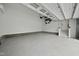 Spacious garage with epoxy floors and ample storage space with automatic garage door at 1005 Keith Rd, Wake Forest, NC 27587