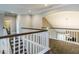 Elegant hallway featuring hardwood floors and a staircase with white railings at 1005 Keith Rd, Wake Forest, NC 27587
