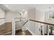 Upstairs landing featuring beautiful wood floors and stairs leading to a view outside at 1005 Keith Rd, Wake Forest, NC 27587