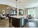 Gourmet kitchen boasts a large island, stainless steel appliances and an open floor plan to the living room at 1005 Keith Rd, Wake Forest, NC 27587
