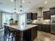 Kitchen features a large island with seating, stainless steel appliances, and an open floor plan at 1005 Keith Rd, Wake Forest, NC 27587