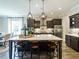 Kitchen features a large island with seating, stainless steel appliances and dark wood cabinets at 1005 Keith Rd, Wake Forest, NC 27587