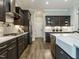 Modern kitchen features stainless steel appliances, dark wood cabinets and bright white countertops at 1005 Keith Rd, Wake Forest, NC 27587