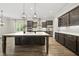 Modern kitchen with marble island, stainless appliances, and beautiful cabinetry and lighting at 1005 Keith Rd, Wake Forest, NC 27587