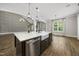 Kitchen boasts a center island with a farmhouse sink and stainless steel appliances at 1005 Keith Rd, Wake Forest, NC 27587