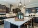 Kitchen features a large island with seating, stainless steel appliances and dark wood cabinets at 1005 Keith Rd, Wake Forest, NC 27587