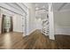 Bright living room featuring hardwood floors, classic wainscoting, an open staircase, and tall windows with views to the outside at 1005 Keith Rd, Wake Forest, NC 27587