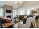Spacious living room with fireplace, TV, high ceilings, and seamless flow to the kitchen at 1005 Keith Rd, Wake Forest, NC 27587